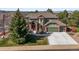 Two-story home featuring a three-car garage, beautiful landscaping and a welcoming entryway at 10831 Eagle Crest Ln, Parker, CO 80138