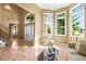 Sun-filled foyer with hardwood floors, large windows, and an arched doorway at 10831 Eagle Crest Ln, Parker, CO 80138