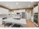 Spacious kitchen featuring a large island with seating, stainless appliances, and white cabinets at 10831 Eagle Crest Ln, Parker, CO 80138