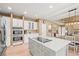 Kitchen with large island, white cabinets, stainless steel appliances, and an eat-in table at 10831 Eagle Crest Ln, Parker, CO 80138