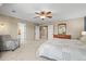 The primary bedroom features neutral decor, a ceiling fan, and an en suite bathroom at 10831 Eagle Crest Ln, Parker, CO 80138
