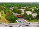 A picturesque aerial shot of a tree-covered bridge over a roadway in a residential neighborhood at 930 W Dry Creek Rd, Littleton, CO 80120
