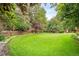 Large, lush backyard with manicured lawn and mature trees, creating a private outdoor space at 930 W Dry Creek Rd, Littleton, CO 80120