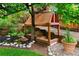 Charming backyard play area with a raised playhouse, surrounded by lush greenery and landscaping at 930 W Dry Creek Rd, Littleton, CO 80120