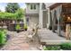 Serene backyard with a hot tub, stone walkway, and an inviting covered patio at 930 W Dry Creek Rd, Littleton, CO 80120