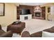 Cozy basement with a brick fireplace, entertainment center, and comfortable seating at 930 W Dry Creek Rd, Littleton, CO 80120