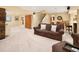 Spacious basement with a large sofa, wooden accents, and bar with seating at 930 W Dry Creek Rd, Littleton, CO 80120