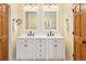 Bathroom features a double vanity with a white countertop and dark bronze fixtures at 930 W Dry Creek Rd, Littleton, CO 80120