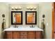 Bathroom features a dual vanity with marble countertop and matching bronze fixtures at 930 W Dry Creek Rd, Littleton, CO 80120