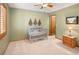 Charming bedroom with a crib, soft carpet, and a ceiling fan for added comfort at 930 W Dry Creek Rd, Littleton, CO 80120