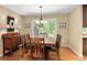 Elegant dining room featuring a chandelier, large windows with shutters, and a wooden dining table with seating for six at 930 W Dry Creek Rd, Littleton, CO 80120