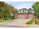 Lovely two-story home with a brick and siding exterior, lush lawn, and a spacious driveway at 930 W Dry Creek Rd, Littleton, CO 80120