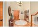 Inviting foyer featuring a wooden front door, hardwood floors, and a chandelier, creating a grand entrance at 930 W Dry Creek Rd, Littleton, CO 80120