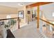 Upstairs hallway features a wood beam accent and wood railing with access to the bedrooms at 930 W Dry Creek Rd, Littleton, CO 80120