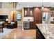 Spacious kitchen with granite countertops, a wine fridge, and stainless steel appliances at 930 W Dry Creek Rd, Littleton, CO 80120
