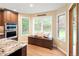 Bright kitchen with an oven, a large window and a breakfast nook with bench seating at 930 W Dry Creek Rd, Littleton, CO 80120