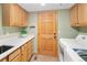 Bright laundry room features a utility sink, cabinet storage and a washer dryer at 930 W Dry Creek Rd, Littleton, CO 80120