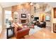Cozy living room with a brick fireplace, built-in shelves, and comfortable seating, creating a warm and inviting atmosphere at 930 W Dry Creek Rd, Littleton, CO 80120