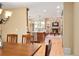 Open concept living space with a view of the kitchen island, brick fireplace, and comfortable seating areas at 930 W Dry Creek Rd, Littleton, CO 80120