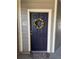 Close-up of the front door, adorned with a decorative wreath at 17346 Nature Walk Trail Trl # 105, Parker, CO 80134