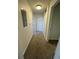 Neutral hallway features brown carpet, white walls, and access to various rooms, illuminated by overhead lighting at 17346 Nature Walk Trail Trl # 105, Parker, CO 80134