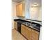 Kitchen with stainless steel sink, granite counters, and natural wood cabinets at 17346 Nature Walk Trail Trl # 105, Parker, CO 80134