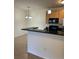 Kitchen featuring a breakfast bar overlooking a separate dining area at 17346 Nature Walk Trail Trl # 105, Parker, CO 80134