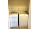 Functional laundry area equipped with a washer, dryer, and overhead shelving for organized storage at 17346 Nature Walk Trail Trl # 105, Parker, CO 80134