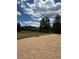 Sand volleyball court with view of the condos, surrounded by lush green space at 17346 Nature Walk Trail Trl # 105, Parker, CO 80134