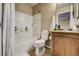 Clean bathroom with a shower/tub combo and wood vanity at 2389 Quartz St, Castle Rock, CO 80109