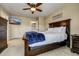 Spacious bedroom with a wooden bed frame and a large TV at 2389 Quartz St, Castle Rock, CO 80109