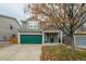 Two-story house with green garage door and landscaping at 2389 Quartz St, Castle Rock, CO 80109