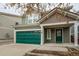 Two-story house with green garage door and landscaping at 2389 Quartz St, Castle Rock, CO 80109