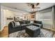 Open living room with L-shaped sectional sofa and large TV at 2389 Quartz St, Castle Rock, CO 80109