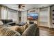 Living room with sectional sofa, fireplace, and large TV at 2389 Quartz St, Castle Rock, CO 80109