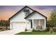 White farmhouse-style home with a two-car garage and welcoming front porch at 39732 Penn Rd, Elizabeth, CO 80107