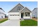 Charming home featuring a two-car garage, stylish gray and white color scheme, and a well-manicured lawn at 39732 Penn Rd, Elizabeth, CO 80107