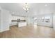Open concept home showcases kitchen featuring white cabinets, large island and stainless steel appliances at 39732 Penn Rd, Elizabeth, CO 80107