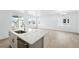 Bright, open kitchen with stainless steel appliances and island with quartz countertop at 39732 Penn Rd, Elizabeth, CO 80107