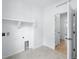 Bright laundry room features tile floors, a utility sink, and built-in shelving at 39732 Penn Rd, Elizabeth, CO 80107