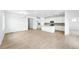 Bright, open-concept living room and kitchen with hardwood floors and modern lighting fixtures at 39732 Penn Rd, Elizabeth, CO 80107