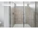 Contemporary shower with glass door, tiled walls, and built in shower head at 39732 Penn Rd, Elizabeth, CO 80107