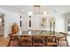 Dining room with a modern light fixture and large wooden table with seating for eight at 5700 E Bayaud Ave, Denver, CO 80224