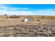 An aerial view of a home and large metal shop building on a spacious lot at 22990 County Road 30, Hudson, CO 80642