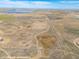 Aerial view of the land, including the boundaries, shows lake and distant developments at 22990 County Road 30, Hudson, CO 80642