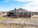 Spacious backyard with a fenced perimeter and patio, perfect for relaxing outdoors at 22990 County Road 30, Hudson, CO 80642