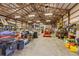 Wide angle shot of the barn interior with equipment and ample storage space at 22990 County Road 30, Hudson, CO 80642