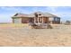 Charming brick home with a well-manicured lawn and rustic western wagon art at 22990 County Road 30, Hudson, CO 80642