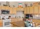 A well-organized kitchen features light wood cabinetry, stainless steel appliances, and plenty of counter space at 22990 County Road 30, Hudson, CO 80642