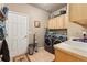 Functional laundry room with modern washer and dryer, ample cabinets, and a utility sink at 22990 County Road 30, Hudson, CO 80642